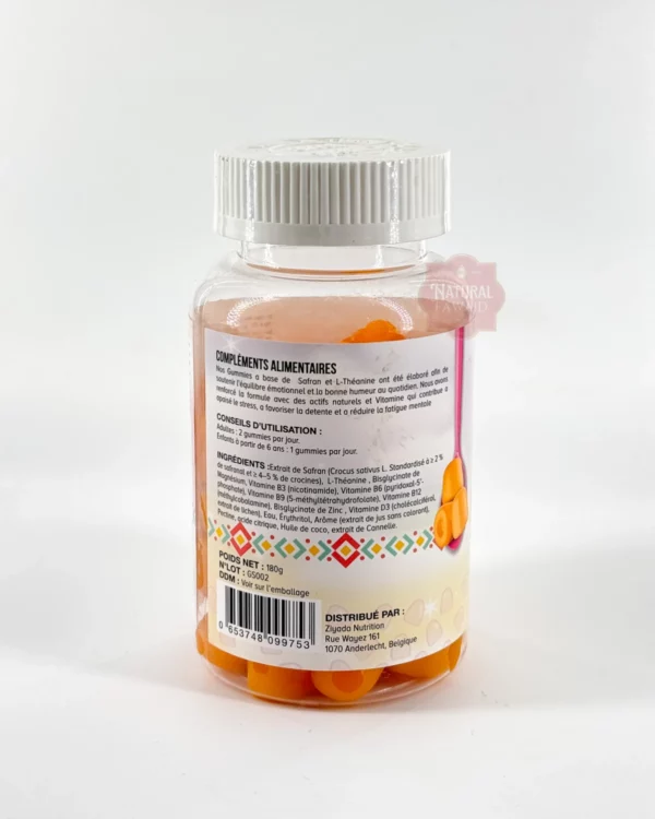 gummies-no-stress-safran-ziyada Gummies orange posés près de fleurs de crocus violettes et de stigmates de safran rouges